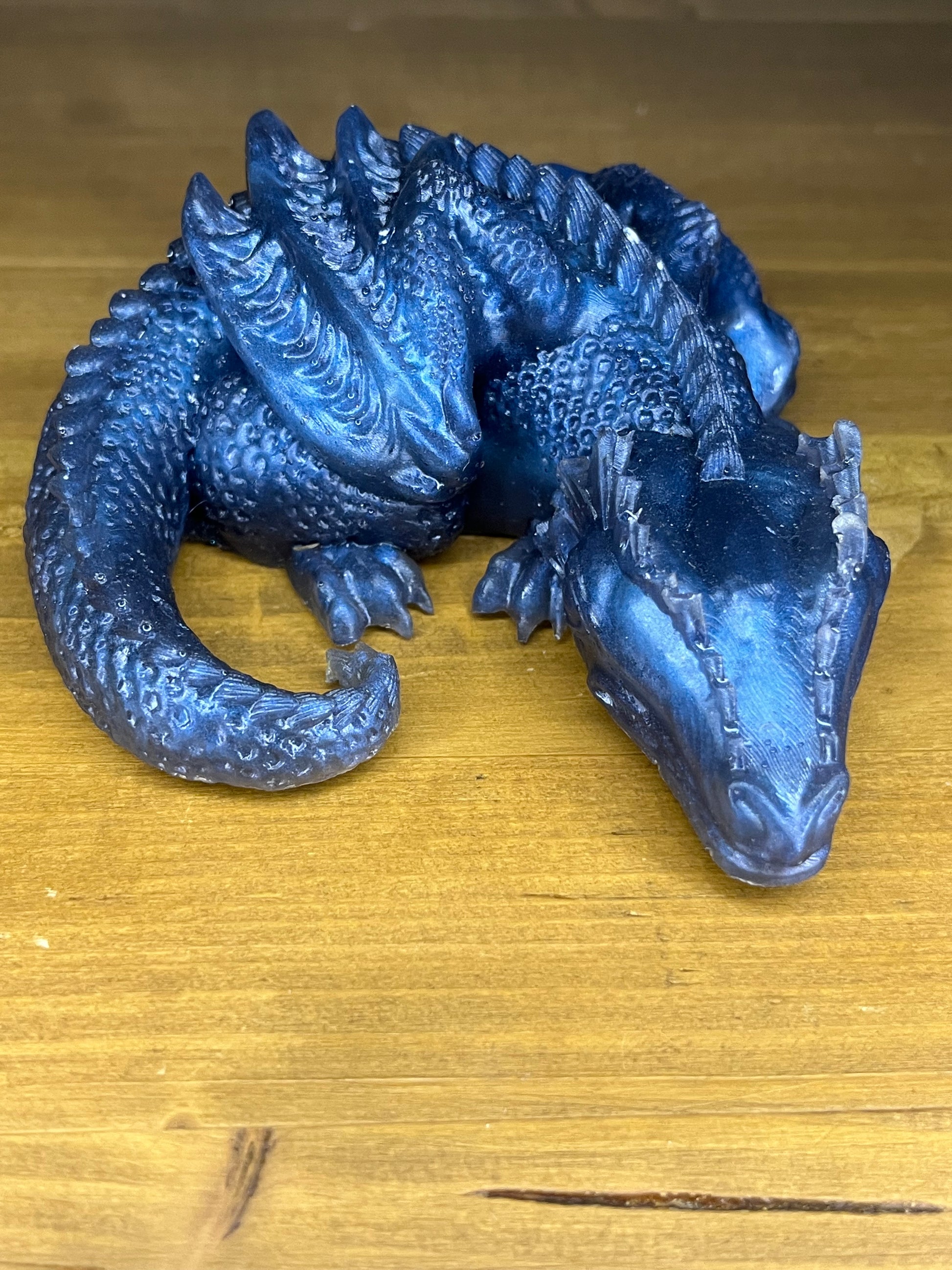 Blue dragon figurine on a wooden surface