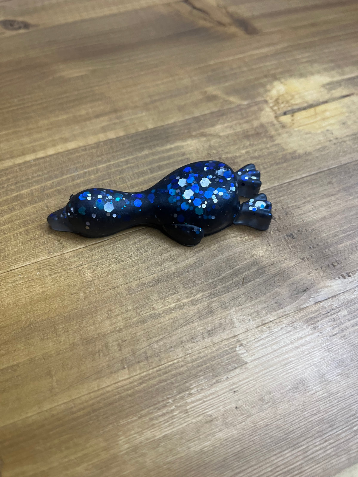 Resin Duck Figurine, Black with Blue Glitter Accent, Lying Collectible