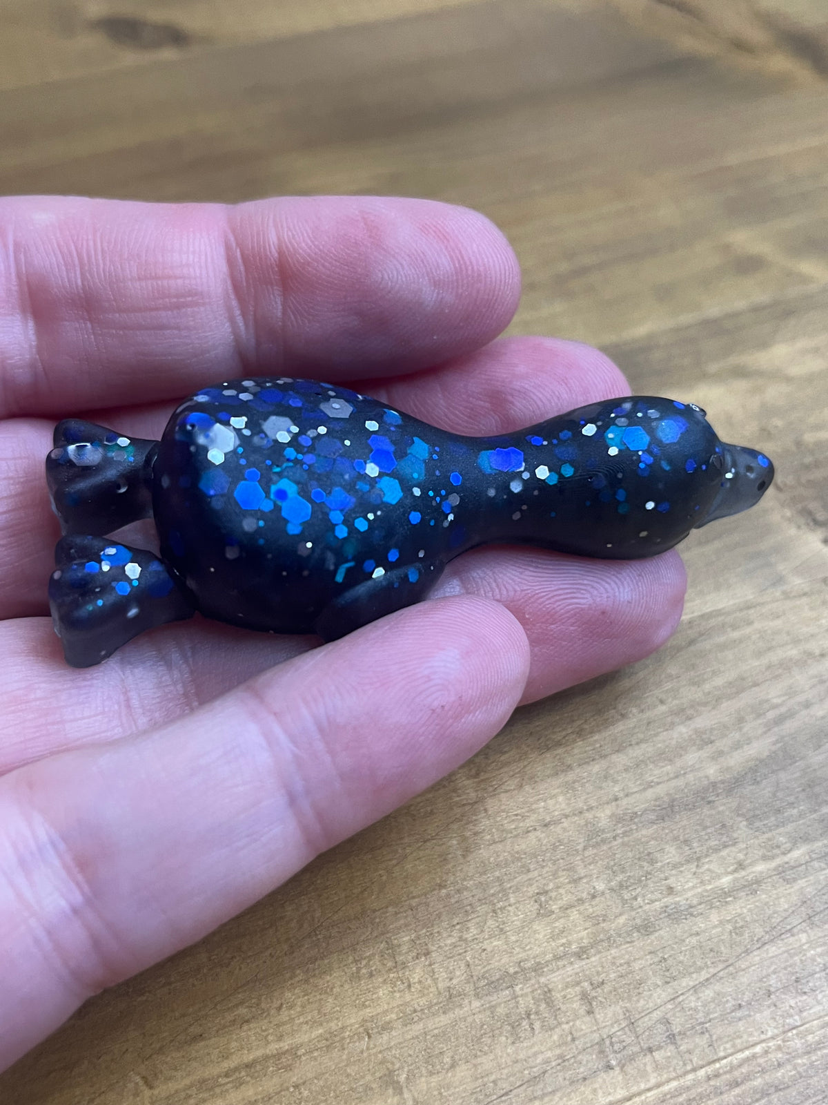 Resin Duck Figurine, Black with Blue Glitter Accent, Lying Collectible