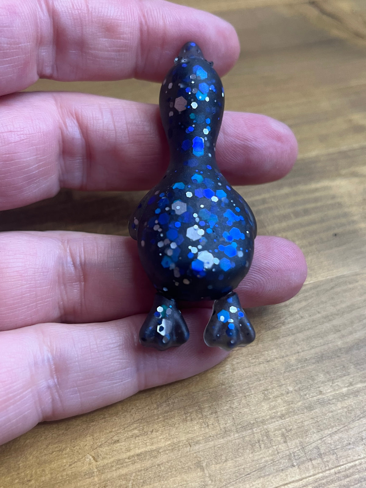 Resin Duck Figurine, Black with Blue Glitter Accent, Lying Collectible